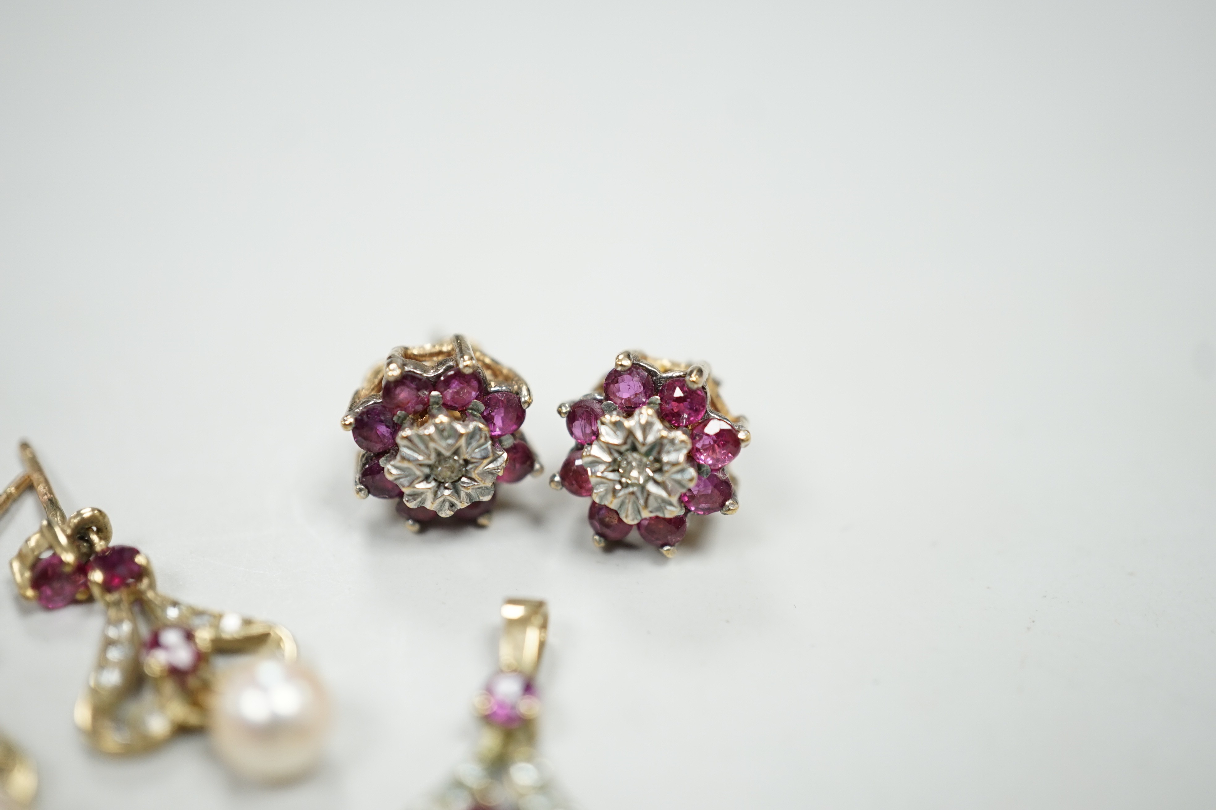 A modern 9ct gold, ruby, diamond and cultured pearl set drop pendant, 22mm and a pair of matching earrings, together with a pair of ruby and diamond cluster set ear studs, gross weight 5.7 grams.